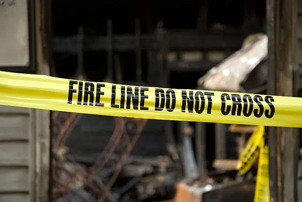 Fire line in front of a fire-damaged building.